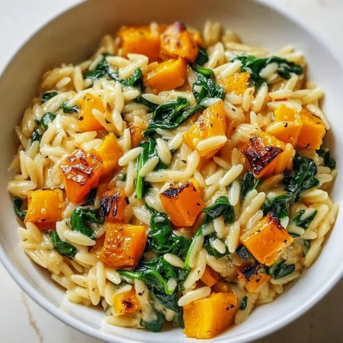 Creamy orzo with roasted butternut squash and spinach in a bowl