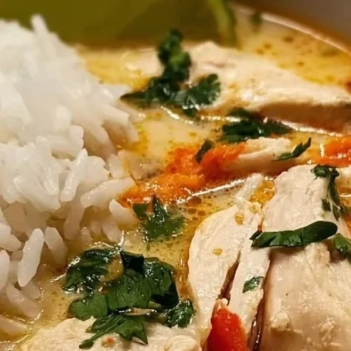 One-Pot Coconut Chicken Brothy Rice in a bowl with herbs and spices