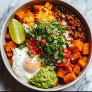 Colorful sweet potato taco bowl with toppings and fresh ingredients