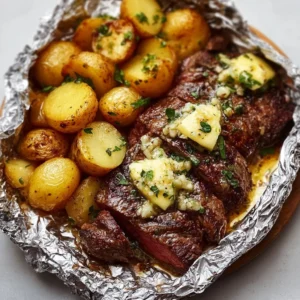 Garlic Butter Steak and Potato Foil Packets in a grill setting