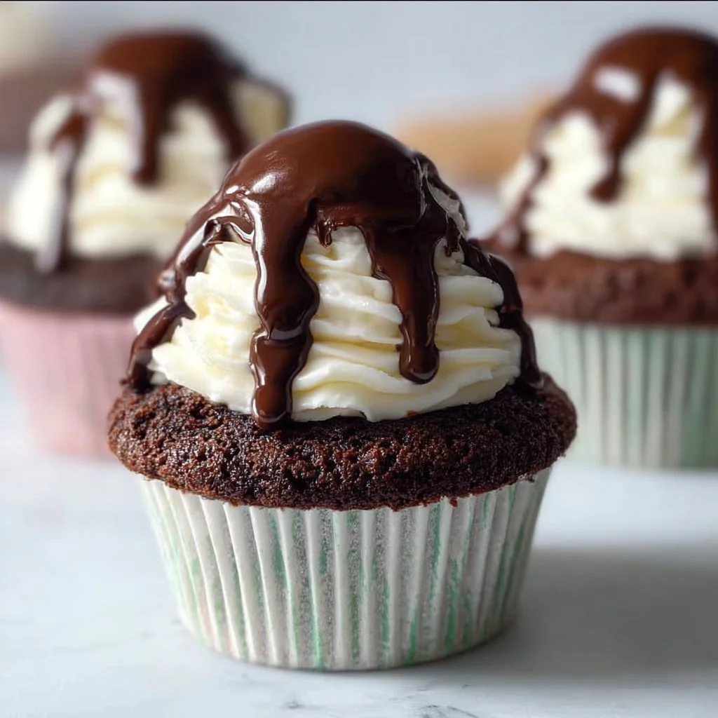 Dreamy chocolate cupcakes with white buttercream filling and chocolate ganache topping